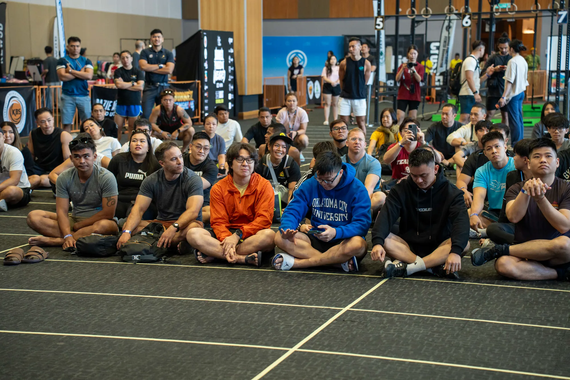 Athletes and spectators gathered around the competition floor