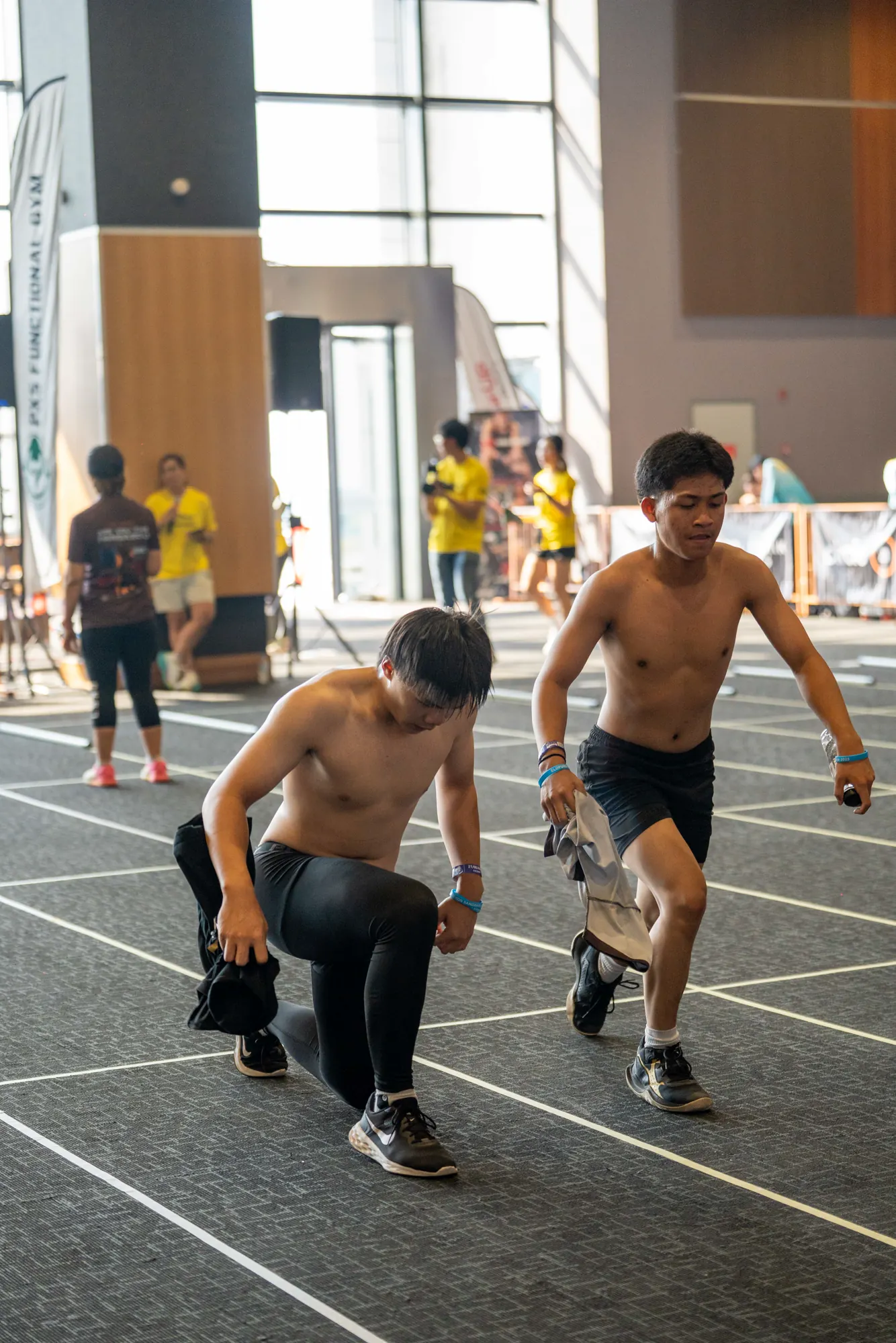 Two competitors sprinting through a workout