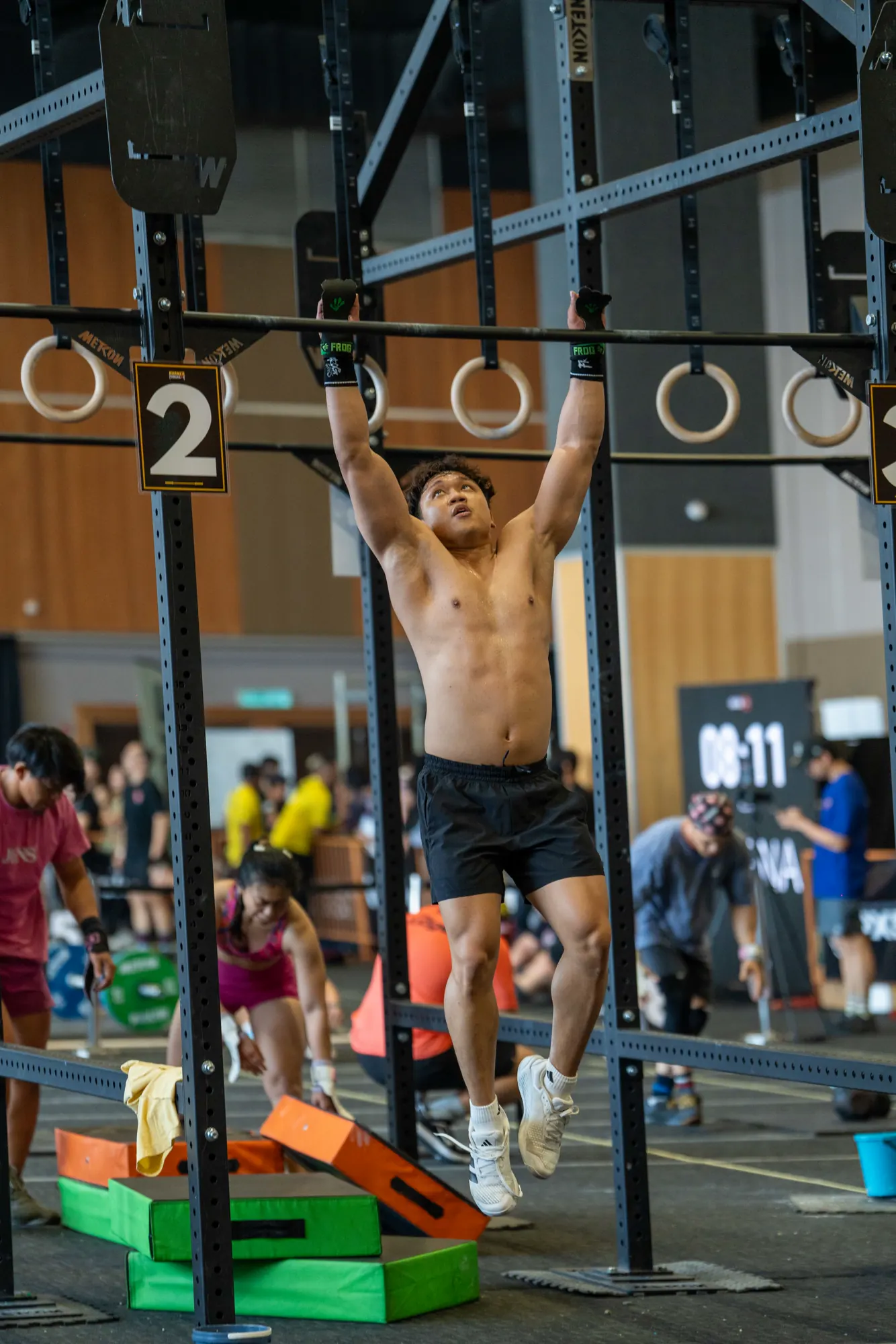 Athlete working through a pull-up rig station