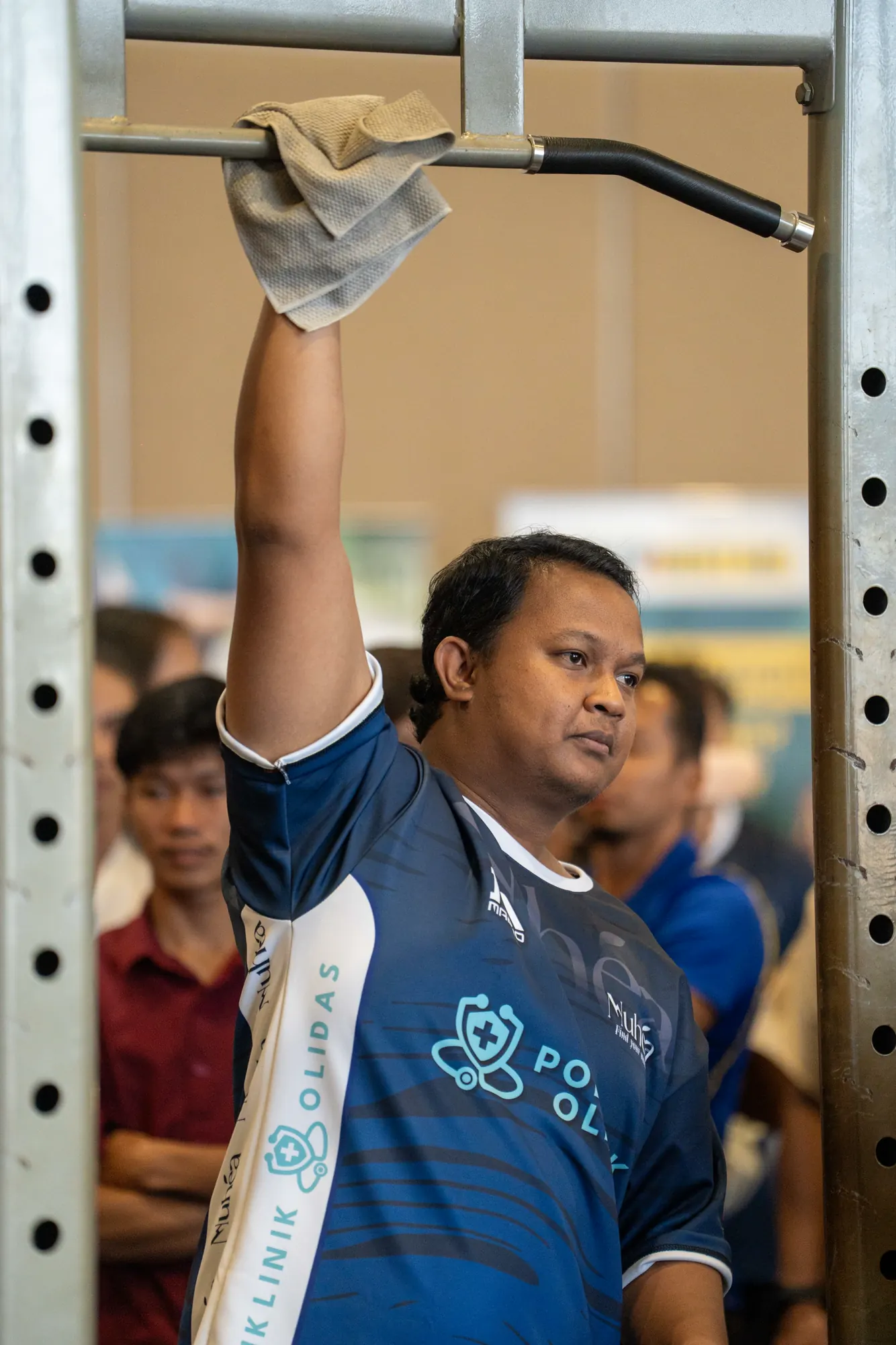 Competitor hanging from the pull-up bar
